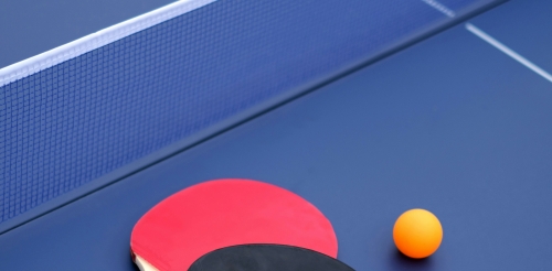 ping pong paddles and ball on table