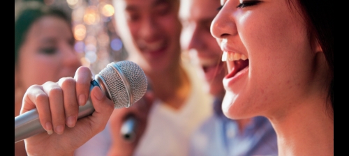 woman sings in microphone