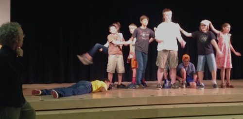 Students on stage, as instructor John Mulvey looks on, during the Young Actors Workshop at the Plaza Branch.